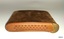Cover has three rows of star cut-outs with red background. A textured brass thumb grip is on one end 