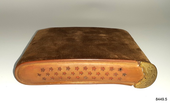 Cover has three rows of star cut-outs with red background. A textured brass thumb grip is on one end 