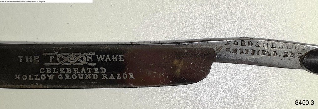 Close-up view of inscriptions impressed on handle and blade