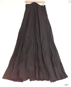Full-length black silky fabric with sunray pleats and a high waistband at the front