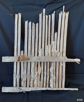 Back of wall section with light coloured mortar between slats