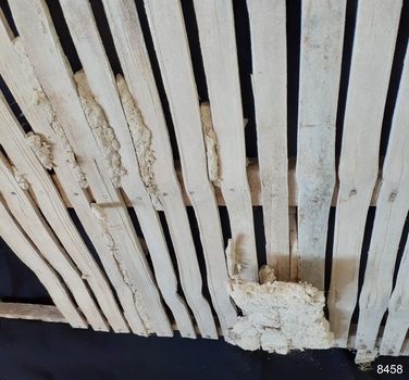 A fragile lump of mortar between and infront of the slats