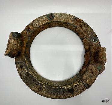 Porthole frame, without glass, signs of restoration attempt