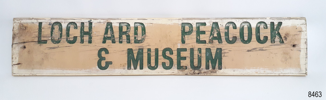 Hand painted sign has a hole in each short side for fixing to a wall