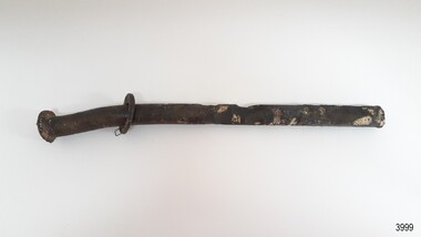 Large metal nail with metal washer attached. Nail is bent and has encrustations