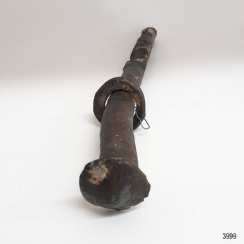 Nail is twisted and indented. The surface has corrosion and encrustations. 