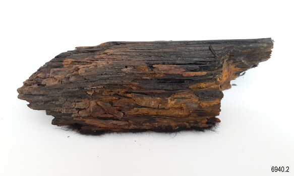 Surface has a charcoal appearance in places and the fur-like appearance at the base