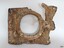 Frame has hinge on the left and handle on the right. The square panel has formed holes. It is encrusted.