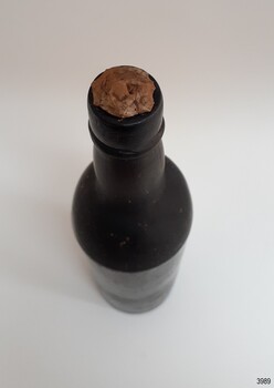 Seal in mouth of black glass bottle. 