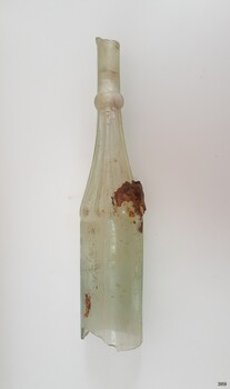 Clear glass bottle with straight upper neck above horizontal neck ring, ribbed from lower neck to shoulders.