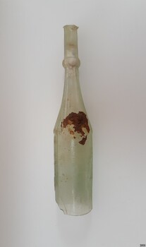 Bottle has an area of thick encrustation where the shoulder and body meet