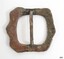 The silver plate has worn off.  The surface is pitted, discoloured with green from copper reaction, and has been lacquered