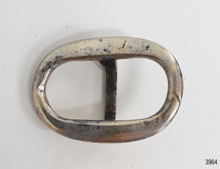 Oval buckle, solver plated, slight indentation on one short inner edge