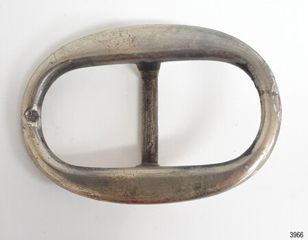 Oval buckle, solver plated, slight indentation on one short inner edge