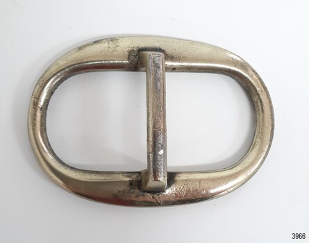Silver-plated surface with nicks and scratches. Made from an oval and a bar shape.