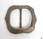 Square buckle, rounded corners, with a slight outwards point in the centre of two sides