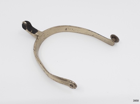 Silver metal spur with some marks and encrustation