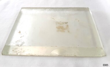 Rectangular section of glass with beveled edges
