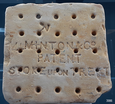 Base of tile, white ceramic surface with five rows of five holes in the base