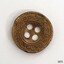 Four holed metal button with decorative border around edge and around holes