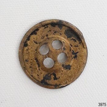 Underside of button has some corrosion and a part of the edge is broken