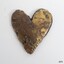 Polished brass decoration, heart shaped. Pitted surface with scratches