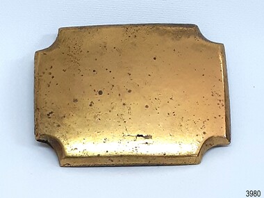 Rectangular brass decoration with corners cut out