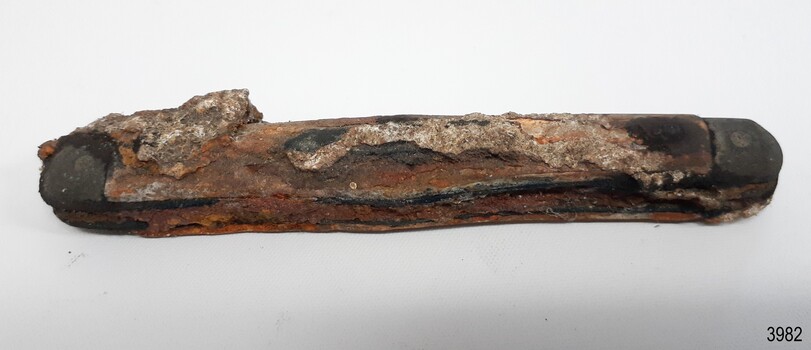 Corroded metal pocket knife with encrustations