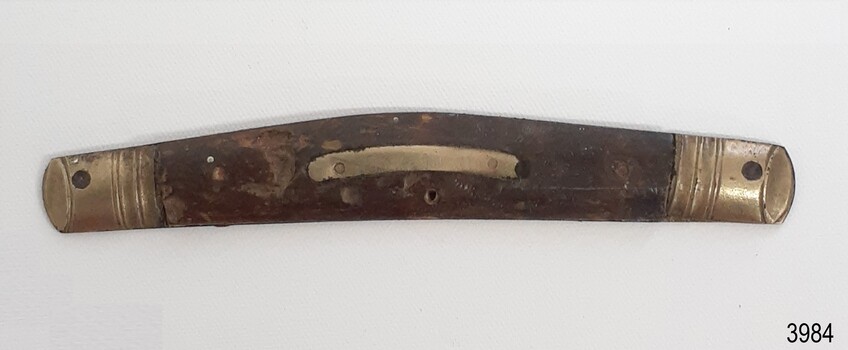 Knife has metal decoration on ends and centre