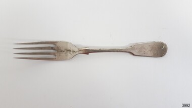 silver coloured fork has fiddle back handle and flared collar