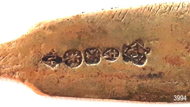 Five stamped inscriptions along the back of the handle 