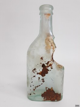 Whole shoulder, imperfections in glass, brown encrustations, varied glass thickness.