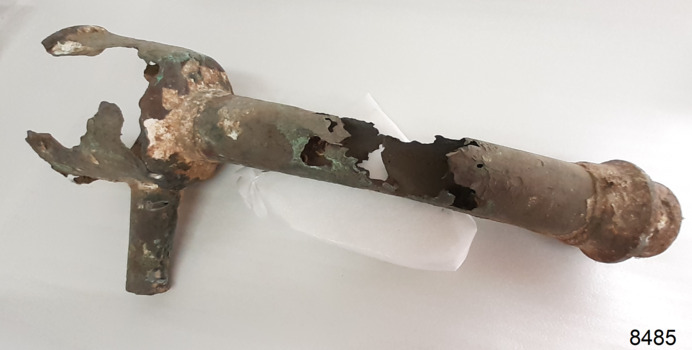 Metal pipe with attached bowl shaped fitting at top with small pipe on its side, and a threaded fitting on other end
