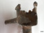 Fitting has part of its side and top missing. It has encrustations on the surface