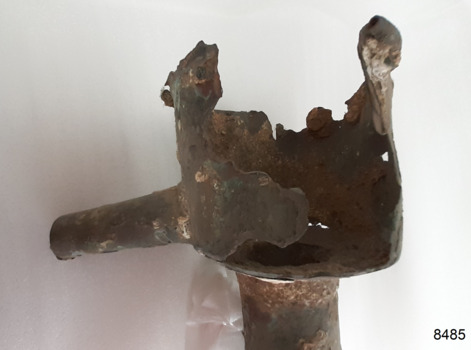 Fitting has part of its side and top missing. It has encrustations on the surface