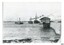 Black and white photograph of Lady Bay with vessels, lifeboat shed and rocket house, Breakwater