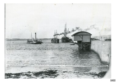Black and white photograph of Lady Bay with vessels, lifeboat shed and rocket house, Breakwater