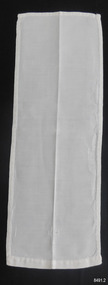 Rectangle of white cloth with white embroidery on one end