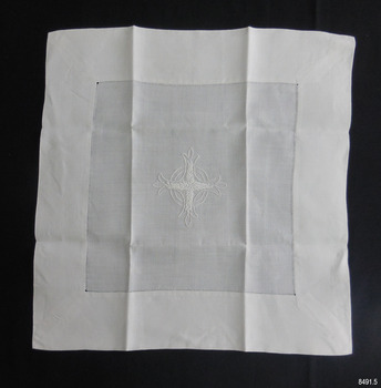 Square white fine cotton fabric, wide hem, embroidered Celtic Cross in front of two rings
