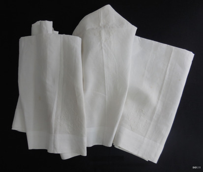 Long white fabric cloth with white, embroidered cross emblems