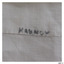 Black pen inscription written onto hem of cloth