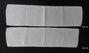 Two white fabric rectangles similar in size, with narrow hems
