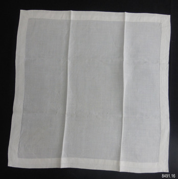Square of fine white linen with hand stitched hem