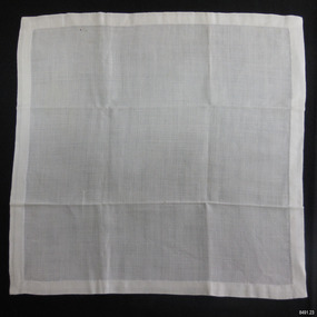 Square of white linen, hand stitched hem