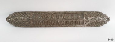 Rectangular metal plate with crisscross pattern and impressed text