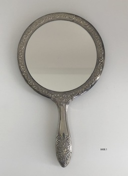 Front view of ornate hand mirror.