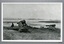 Black and white copy of 2172.1, man seated on one of two cannon carriages overlooking Lady Bay