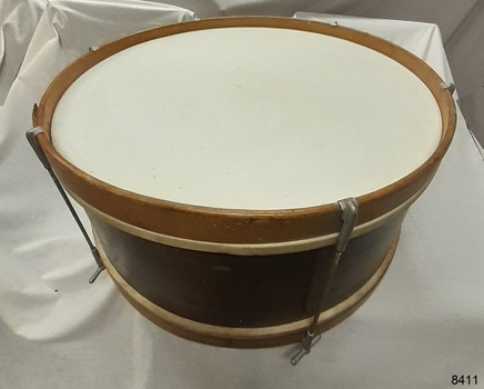 Tight drum skin  painted white, stretched across the drumhead