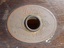Oval brass maker's plate has inscription with maker's name and location