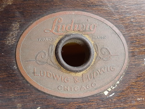 Oval brass maker's plate has inscription with maker's name and location